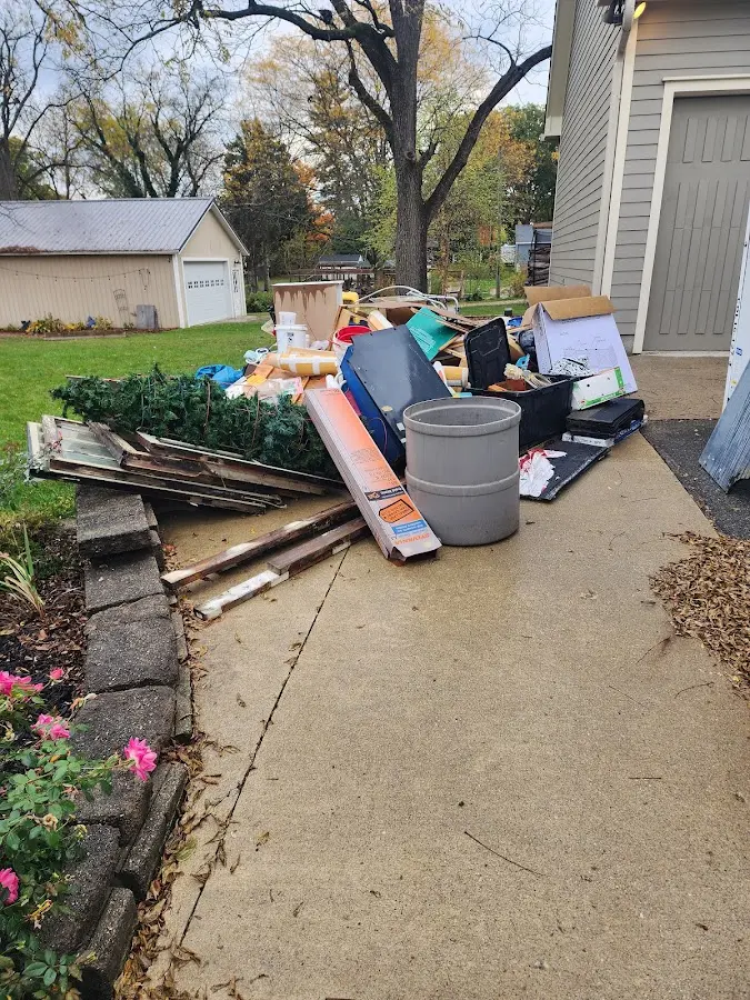 Dumpster being loaded with debris for Estate Cleanout Dumpster Rental in Barron